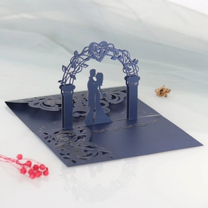 Macro view of navy blue 3D pop-up wedding invitation featuring laser-cut heart archway