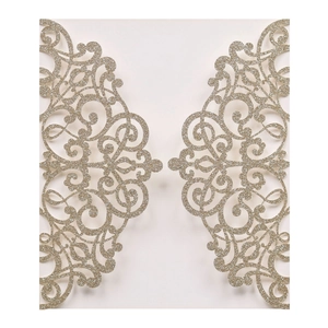 Detail of laser-cut glitter wedding invitation with intricate champagne gold vine patterns