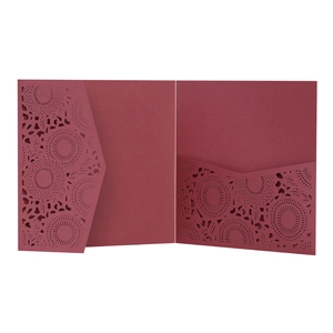 Detail of laser cut lace floral pattern on burgundy wedding invitation card holder