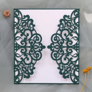 Detailed laser-cut pattern on dark green European wedding invitation with elegant white card