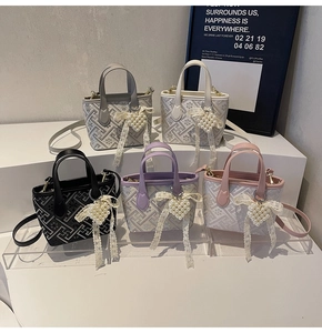 Five small embroidered bucket bags in various colors featuring pearl heart charms