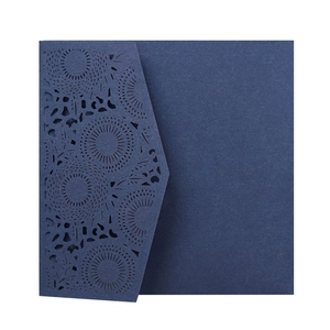 Close-up of navy blue laser-cut lace pattern on elegant wedding invitation cover
