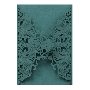 Detail of dark green laser-cut wedding invitation with intricate floral lace patterns