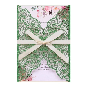 Green glitter laser-cut wedding invitation with lace pattern and white satin bow