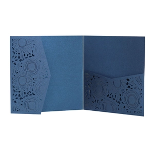 Detail of navy blue laser-cut lace wedding invitation with intricate mandala pocket design