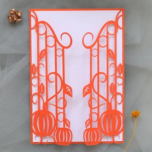 Detail of laser-cut orange pumpkin gate invitation cover with autumn decorations