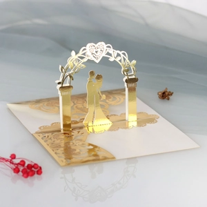 Detailed laser-cut 3D pop-up wedding invitation featuring a golden bride and groom silhouette