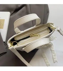 Top view of cream leather bucket bag showing smooth metal zipper and internal compartment