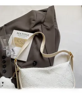 White jacquard shoulder bag featuring a leather logo patch and cute cloud keychain accessory