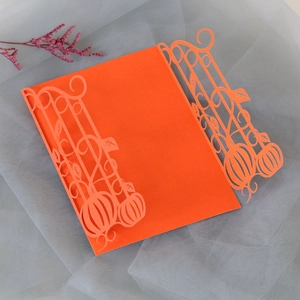 Detailed laser-cut pumpkin and vine design on vibrant orange Halloween invitation card