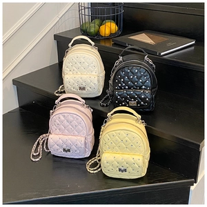 Quilted mini backpacks in four colors with chain straps and rhinestone details on steps