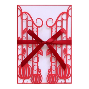Laser-cut hollow orange pumpkin greeting card with elegant red ribbon for Halloween party
