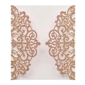 Macro detail of laser-cut rose gold glitter wedding invitation with intricate hollow patterns