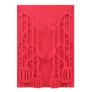 Detail of laser-cut red card with intricate symmetrical floral vine and leaf patterns
