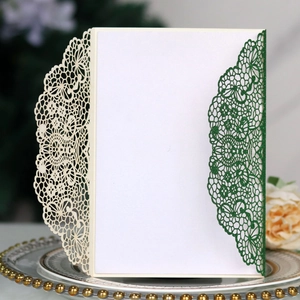 Detail of laser-cut lace invitation card with glitter finish on elegant ceramic plate