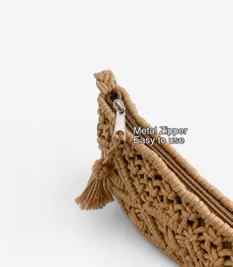 Detail of woven cotton rope bag featuring a silver metal zipper and tassel charm