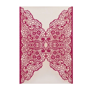 Macro detail of laser-cut lace floral pattern on pink glitter wedding invitation card