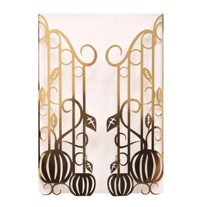 Detail of laser-cut gold pumpkin gate design on festive invitations with metallic finish