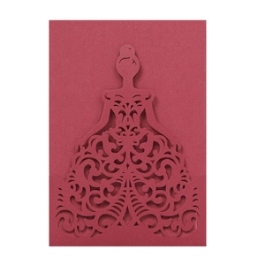 Detail showing the intricate laser cut design of a burgundy wedding invitation card