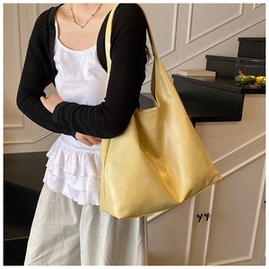 Minimalist pale yellow PU leather tote bag shown in a modern lifestyle home setting