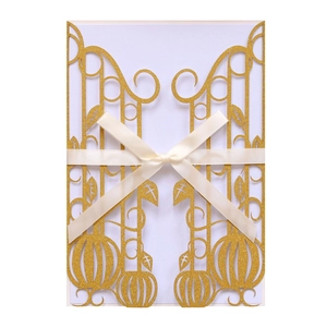 Laser cut hollow wedding invitation in gold glitter with cream silk ribbon bow decoration