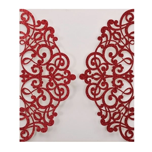 Detail of laser-cut red glitter wedding invitation with elegant damask patterns