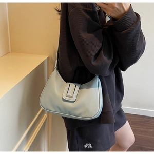 Detail of mint blue crescent shoulder bag featuring premium lychee pattern leather texture