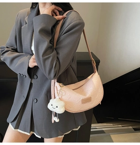 Detail of pink hobo bag with 3D texture and a cute white cloud charm for women