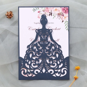 Detailed laser-cut navy blue wedding invitation with elegant floral insert and envelopes
