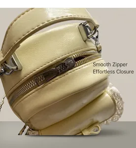 Detailed macro view of the cream PU backpack featuring a smooth zipper and lace trim