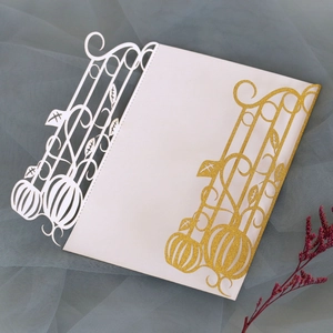 Detail of laser-cut Halloween invitation featuring gold glitter pumpkin and vine patterns