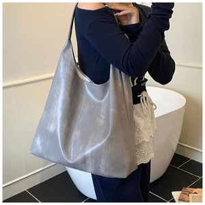 Maillard grey tote bag with textured vintage finish worn as a shoulder hobo bag
