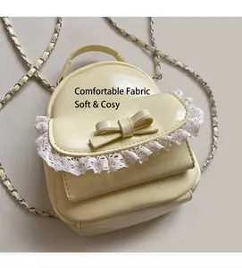Close-up of cream PU leather mini backpack with lace trim and bow knot detail