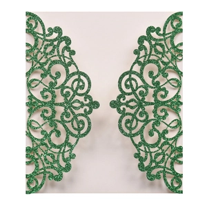 Detail of laser-cut wedding invitation with green glitter and intricate scroll pattern