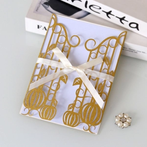 Close-up of laser-cut gatefold invitation with gold glitter texture and cream bow