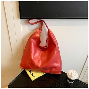 Detailed close-up of a large red Hobo bag crafted from textured glossy PU leather finish