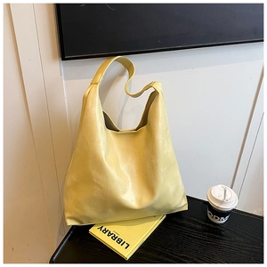Detail view of bright yellow matte leather Hobo tote bag with wide shoulder strap