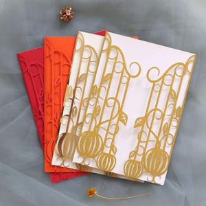 Detail of laser-cut Halloween cards with pumpkin motifs and golden glitter accents