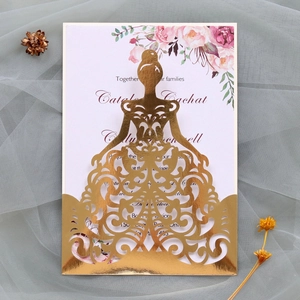 Macro view of laser cut gold gown invitation cover with elegant floral insert