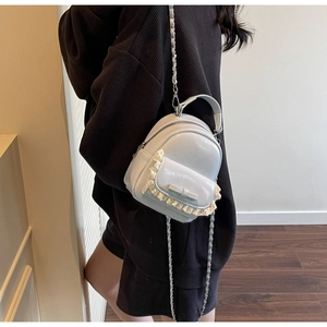 Detailed back view of a light blue mini backpack with lace and bow on a female model