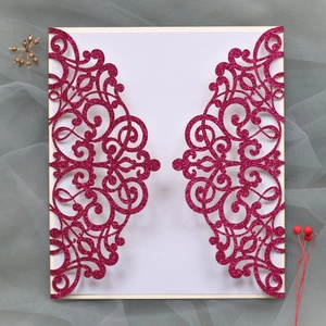 Detailed laser-cut rose gold glitter wedding invitation with elegant scroll patterns
