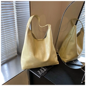 Detail view of the soft leather texture and seamless wide shoulder strap on the hobo bag
