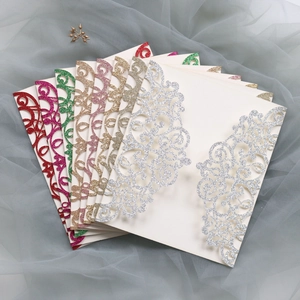 Detail of laser-cut hollow floral invitation cards with sparkling metallic finish