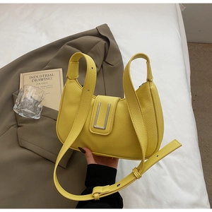 Detail of yellow lychee texture dumpling bag with a silver U-shaped metal buckle