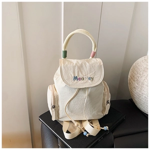 Detail of off-white nylon backpack with MeaRey embroidery and colorful handle wrap