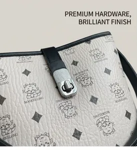 Close-up of silver metal twist lock and pebbled leather texture on cream bucket bag