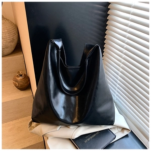 Minimalist black matte leather tote bag shown on elegant stairs with shadow detail