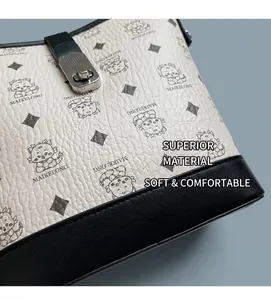 Close-up of beige lychee grain leather handbag with dragon pattern and silver metal lock