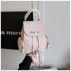 Nahaufnahme des rosa Nylonrucksacks mit MeaRey-Stickerei und gewebtem Seilgriff-Detail