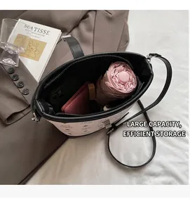 Spacious interior of pink bucket bag showing storage for umbrella, wallet and phone